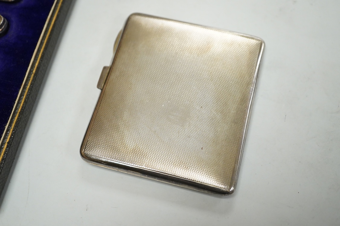 A George V engine turned silver and green enamel cigarette case, by Mappin & Webb, Birmingham, 1932, 82mm and a cased set of six silver handled tea knives.